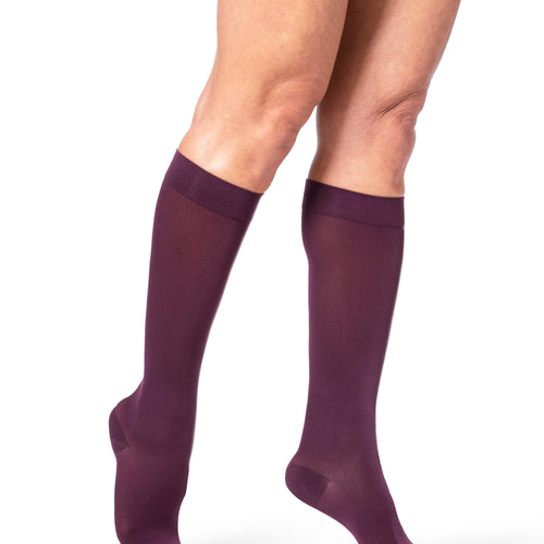 Sigvaris Style Soft Opaque women's compression socks in Mulberry, worn by a model