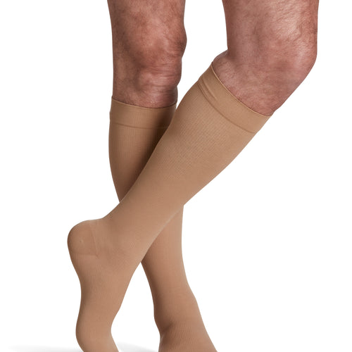 Sigvaris Essential Opaque men's compression socks in Light Beige, worn by a model