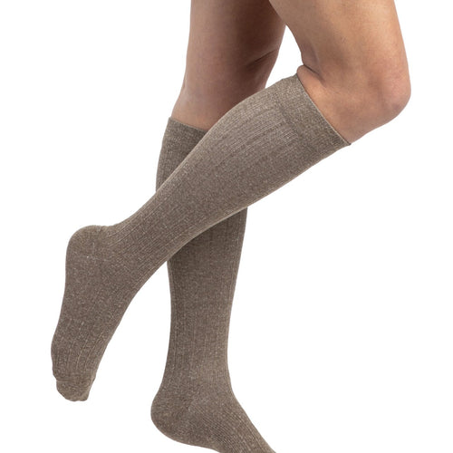 Sigvaris Style Linen women's compression socks in Brown, worn by a model, right-side view