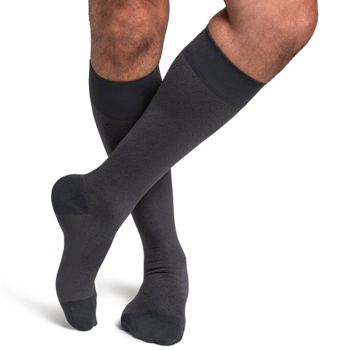 Sigvaris Style Microfibre Patterns men's compression socks in Graphite Confetti, worn by a model, right-side view