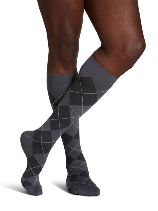 Sigvaris Microfiber Shades men’s compression socks in Graphite Argyle, shown on crossed legs